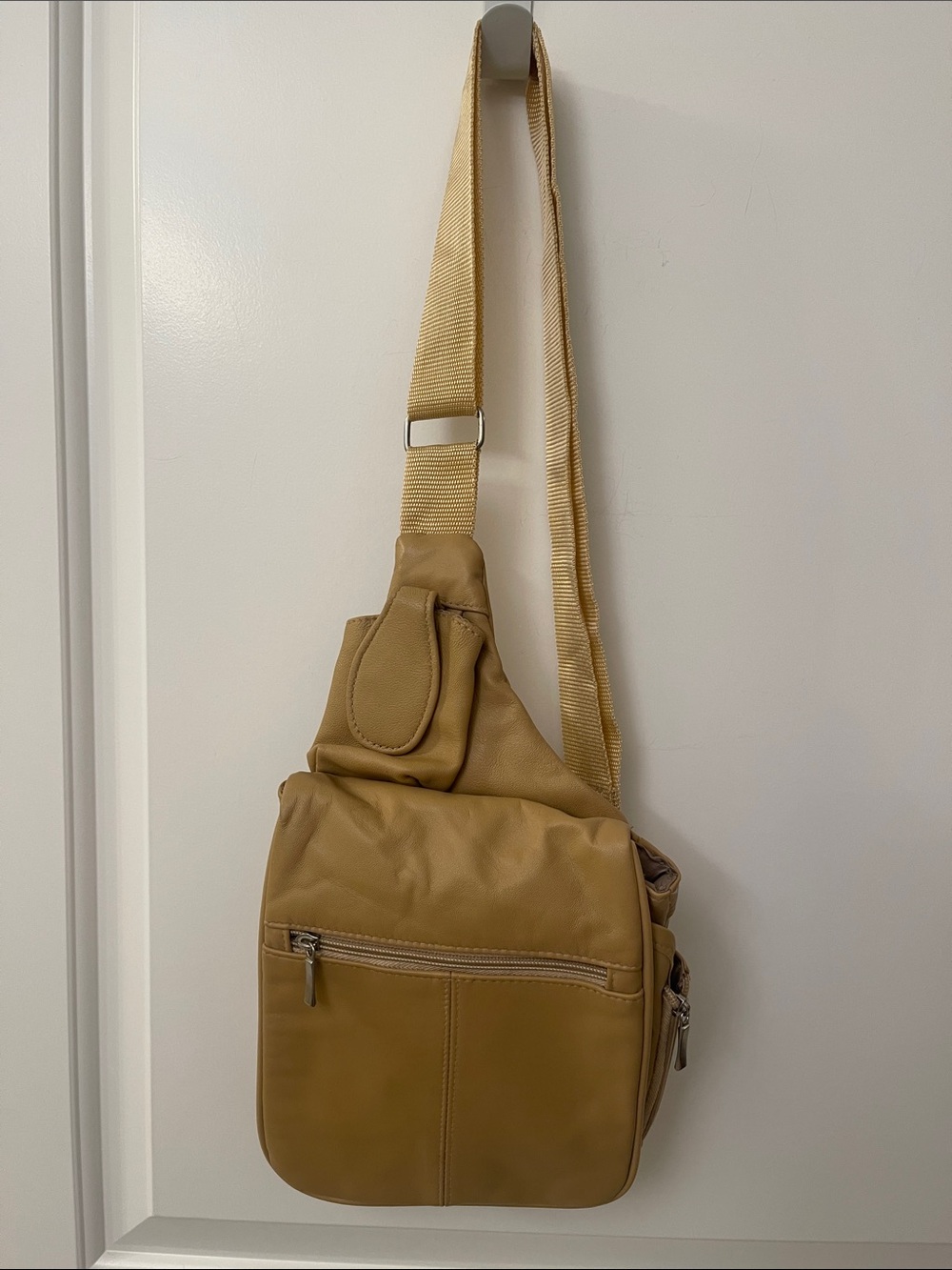 Buxton tan crossbody sling backpack